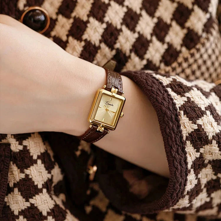 Elegant women's quartz watch with a shiny gold-tone strap & classic white dial.