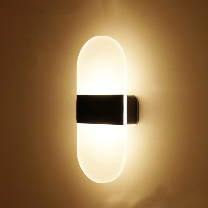 Contemporary LED wall light with motion sensor, magnetic mount for easy indoor lighting setup.