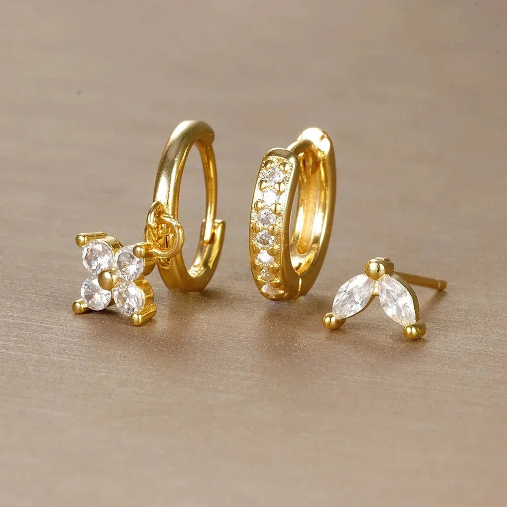 Comfortable women's ear piercing set made from surgical steel, offering hypoallergenic hoops & studs for stacking.