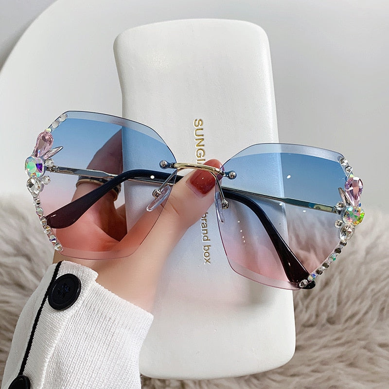 Sparkling rhinestone rimless sunglasses for women, elegant gold frame, fashion accessory.