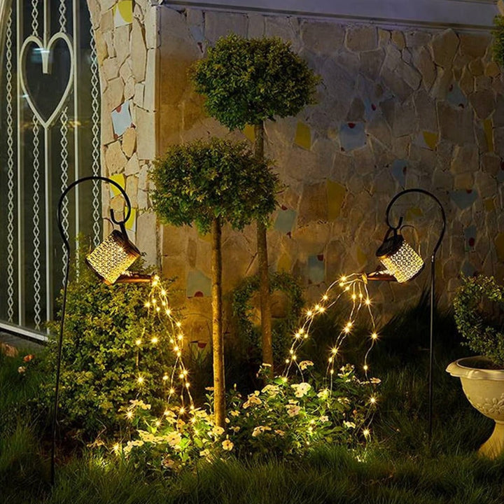 Enchanting solar LED watering can garden lantern, providing warm pouring lights for outdoor landscape decor.