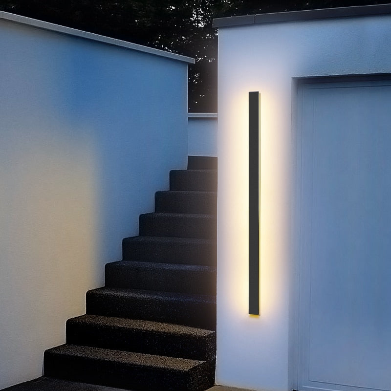 Sleek linear LED outdoor wall light, weatherproof for modern exterior architectural lighting.