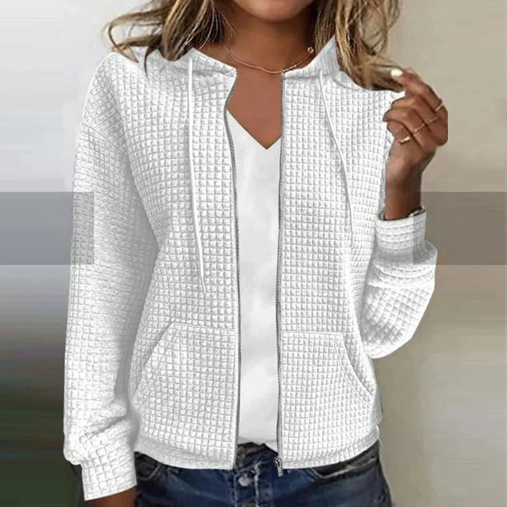 Woman wearing a warm, stylish checked jacket. Water-repellent, perfect everyday winter coat.