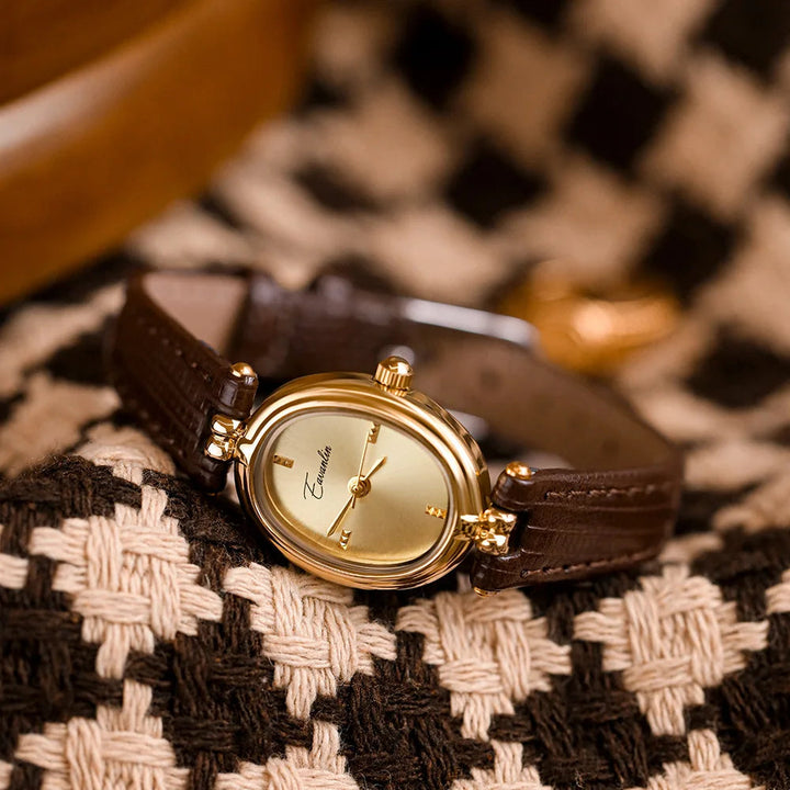 Elegant women's gold-tone quartz watch featuring a sleek rectangular dial, a classic timepiece.