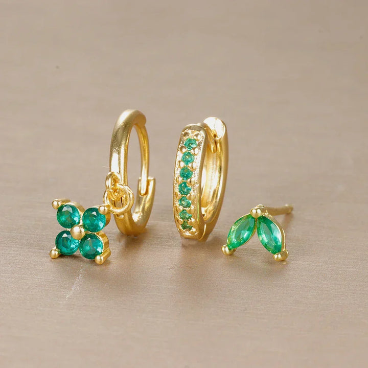 Close-up of a women's minimalist ear piercing set, showcasing comfortable surgical steel studs & hoops.