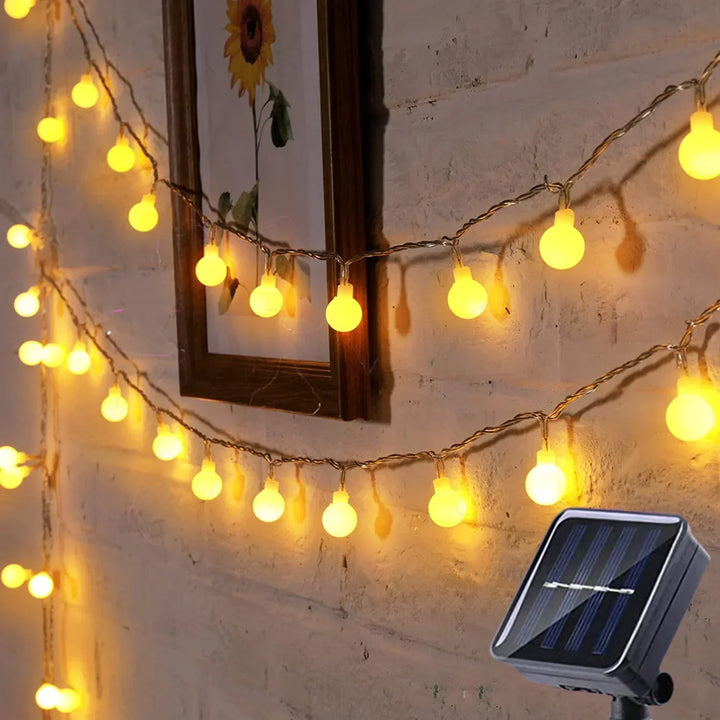 Multicolour solar LED string lights brightening a backyard party ambiance, perfect for garden decor.