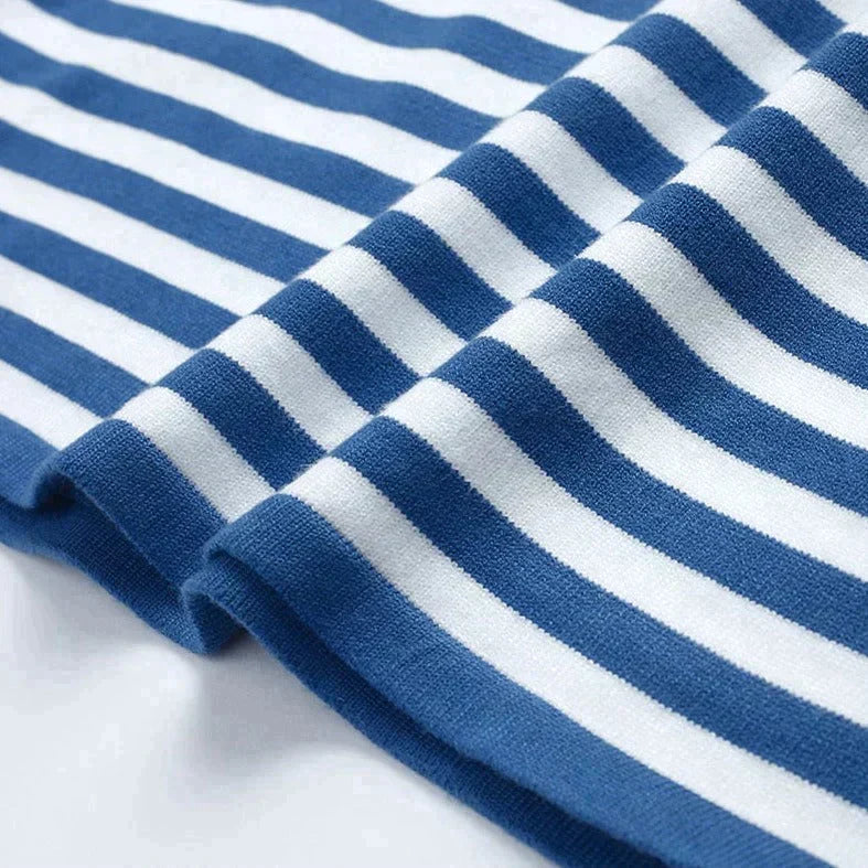 Lifestyle shot: Cozy women's striped knit sweater. Long sleeve crew neck pullover for relaxed autumn fashion.