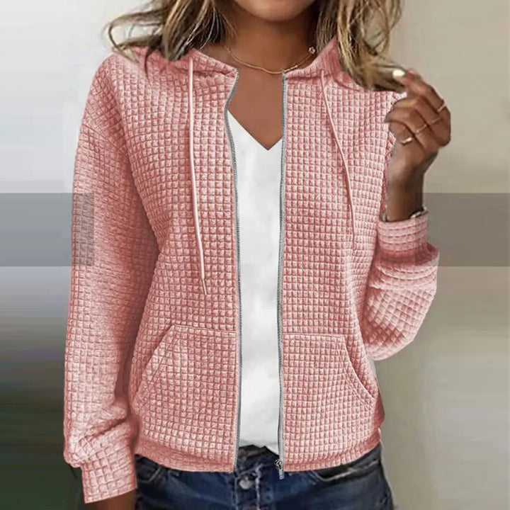 Close-up of a women's checked jacket fabric. Water-repellent, warm winter coat for casual style.