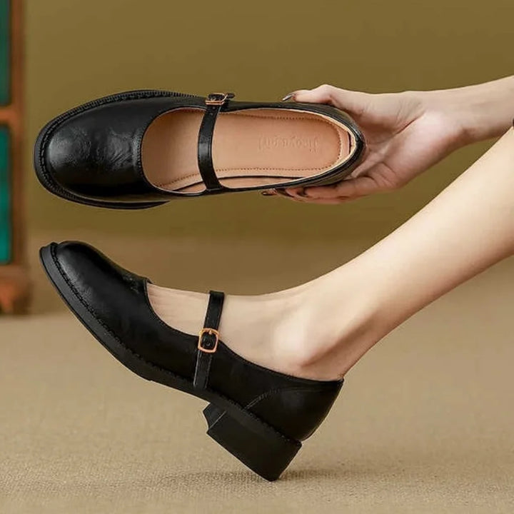 Elegant women's classic Mary Jane flats with a versatile design, low heel, and adjustable strap for various outfits.