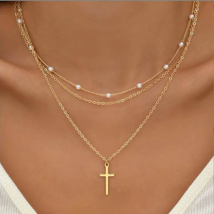 Silver triple layer necklace for women with chic cross pendant. Fashion jewelry, layered design.
