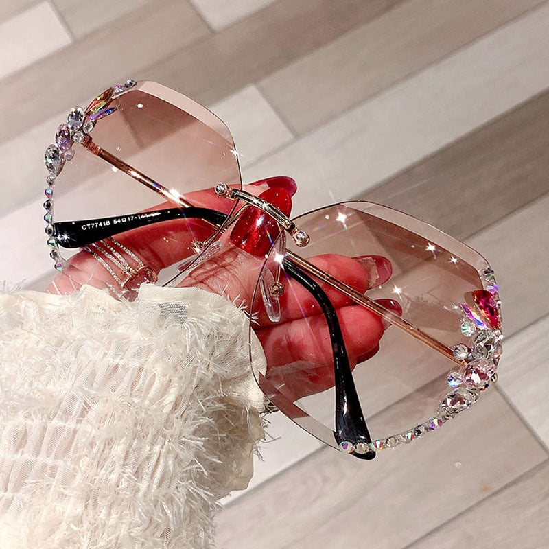 Women's rimless rhinestone sunglasses with a sleek gold frame, essential UV protection eyewear.