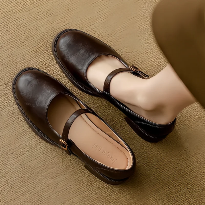 Side view of women's classic Mary Jane flats, showcasing the adjustable strap and low heel for comfortable support.