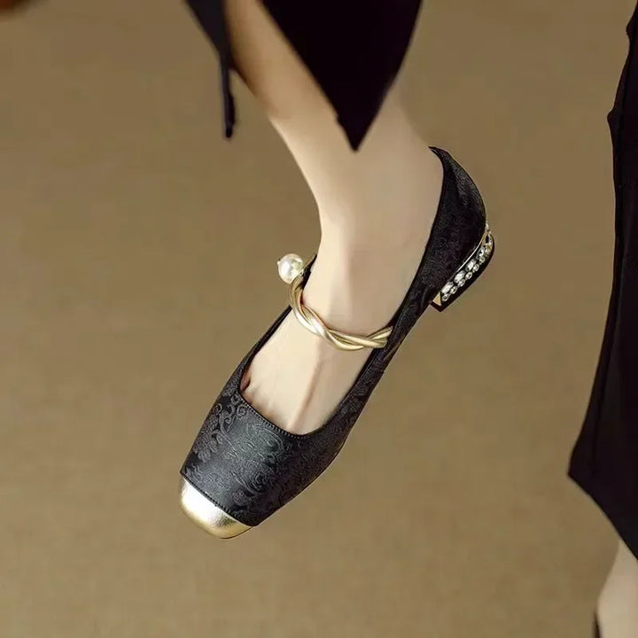 Close-up of pearl strap on women's vintage Mary Jane shoes, showcasing elegant design.