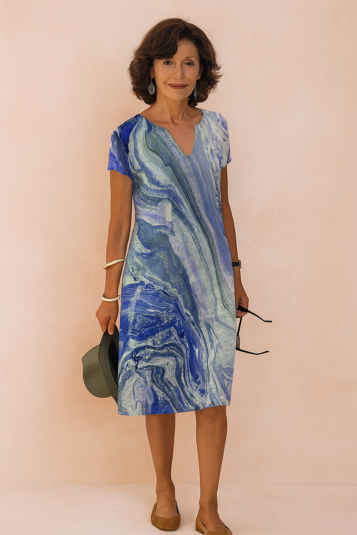 Flowy blue V-neck summer dress, a versatile piece for women. Ideal for elegant or casual wear.