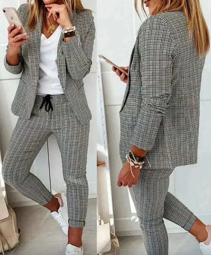 Chic gray women's two-piece business suit, ideal for formal office fashion & professional wear.