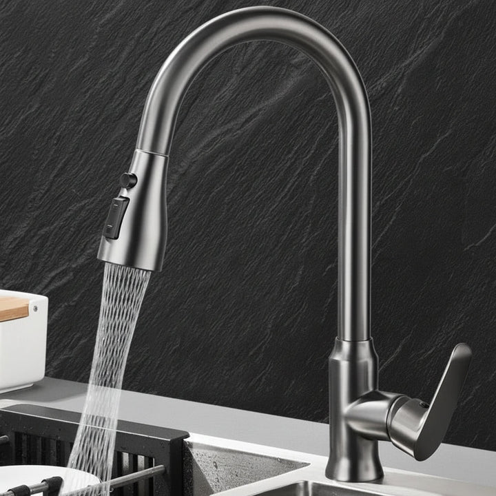Contemporary kitchen faucet fixture installed on a sink, highlighting its pull-out spray feature.