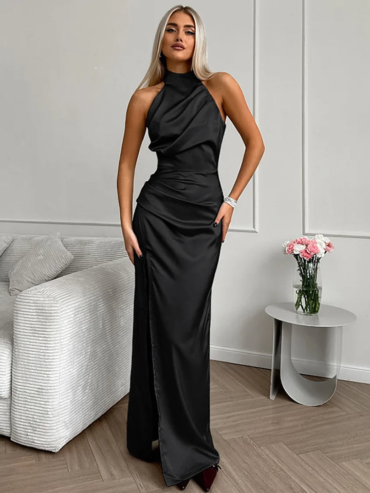 Sleeveless women's halter-neck maxi dress with a flowing silhouette and a stylish thigh slit, great for parties.