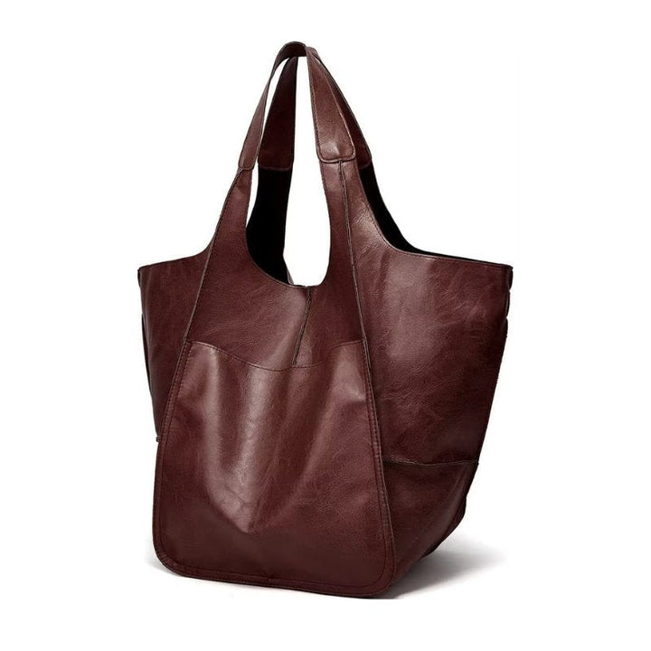 Women's oversized vegan leather tote bag carried, a stylish and practical everyday shoulder bag.