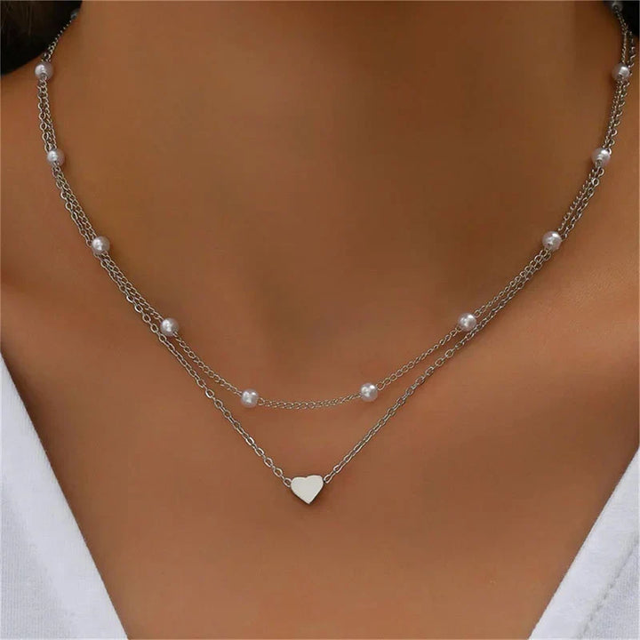 Stylish women's layered necklace featuring triple chains, heart or cross pendant. Perfect gift.