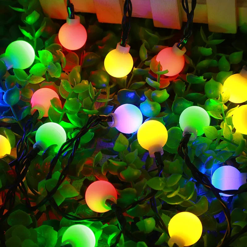 Decorative warm white LED solar string lights creating a cozy ambiance for outdoor garden & patio lighting.