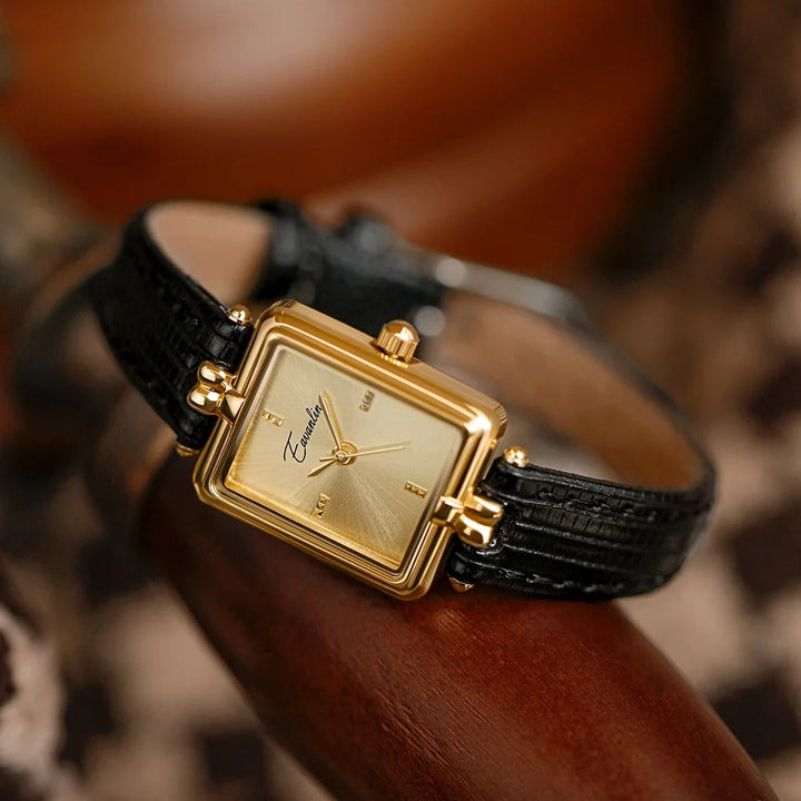 Elegant women's quartz watch with a sophisticated black leather strap and gold-tone case.