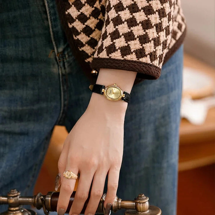 Elegant women's gold-tone quartz watch complementing a formal outfit, a sophisticated timepiece.