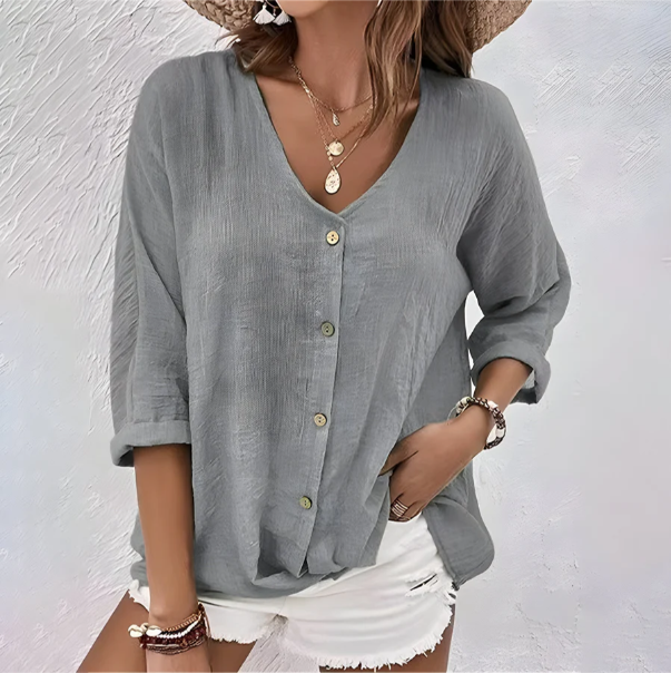 Relaxed fit womens blouse featuring a stylish V-neck & functional roll-up long sleeves. Everyday comfort.