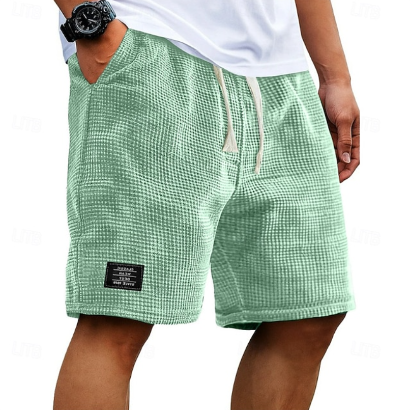 Men's beachwear shorts, textured fabric, comfortable for summer activities.