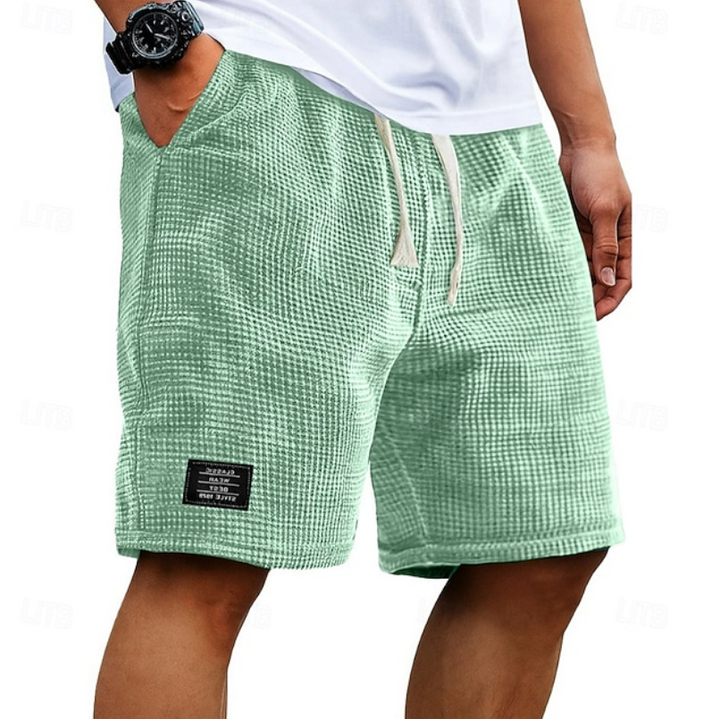 Men's beachwear shorts, textured fabric, comfortable for summer activities.