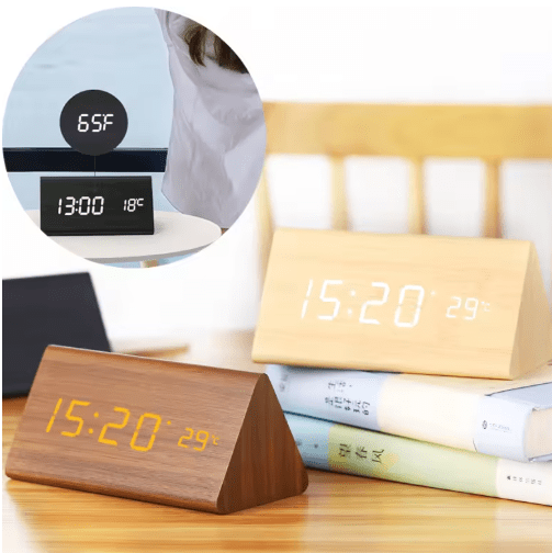 Sleek minimalist LED alarm clock, sound activated for home office.