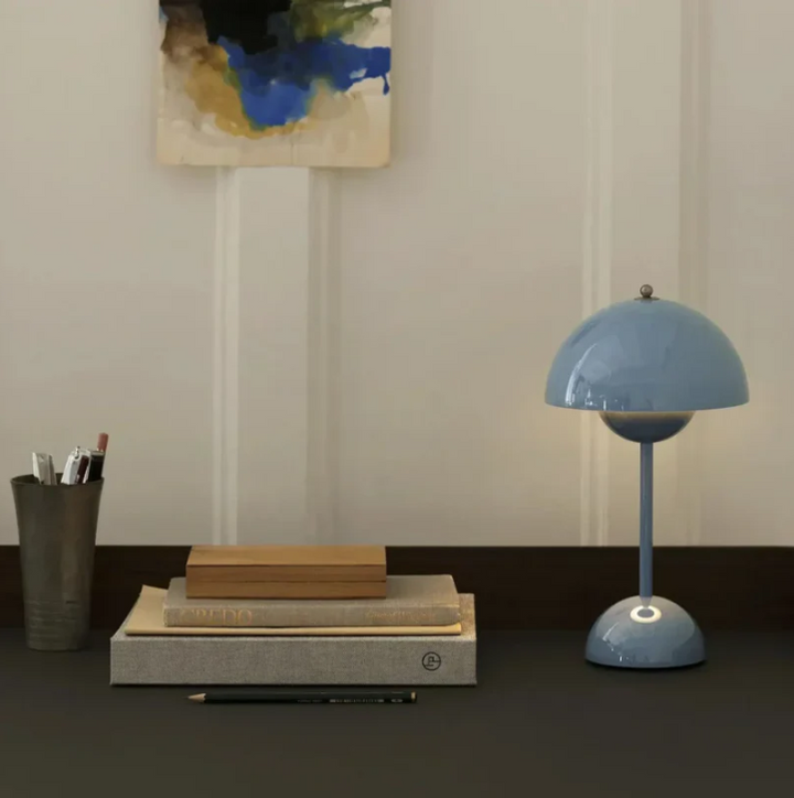 Minimalist modern LED table lamp, touch activated for adjustable brightness levels.