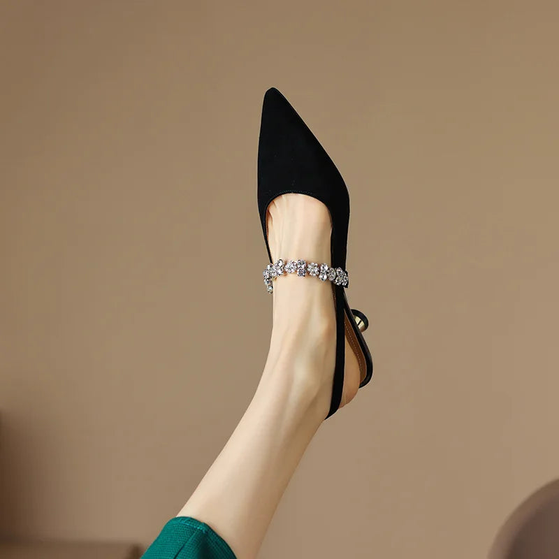 Sophisticated silver pointed toe slingback heels with crystal accents and a practical low heel.