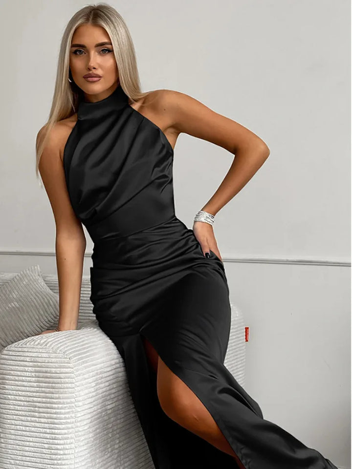 Elegant women's special occasion halter-neck maxi dress with a flattering thigh slit, perfect for evening events.