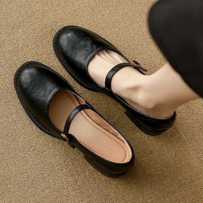 Black women's classic Mary Jane flats with a soft, cushioned interior and adjustable strap for everyday comfort.