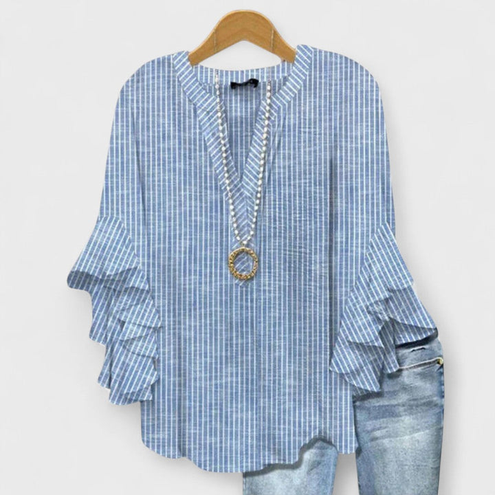 Summer fashion: Women's blouse with elegant ruffled sleeves and a beautiful floral design.