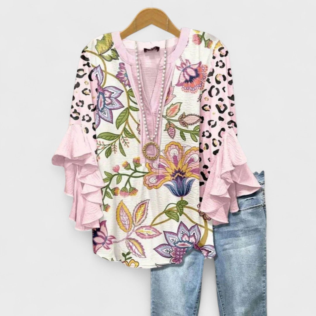 Fashionable women's summer top, featuring elegant ruffled sleeves & a beautiful pattern.