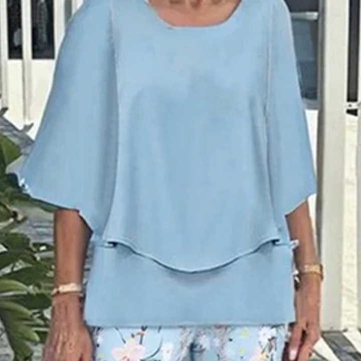 Comfortable women's two-piece outfit set, featuring a relaxed layered top & vibrant leaf print pants. Casual chic.