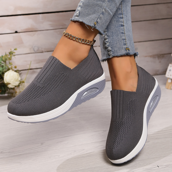 Women's orthopedic slip-on sneakers with arch support, lightweight design for comfortable walking.