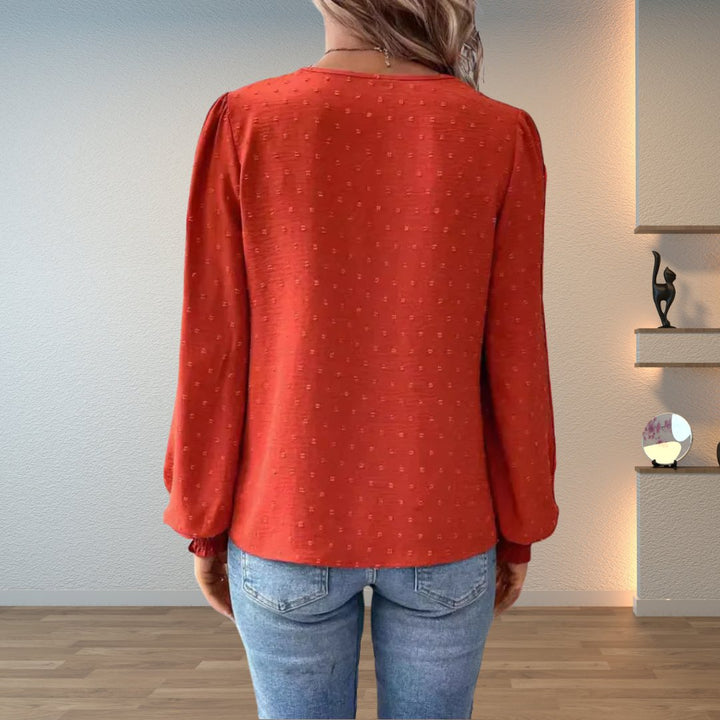 Dressy V-neck women's blouse with elegant lace bodice & long smocked sleeves. Ideal for work, party, or chic casual.
