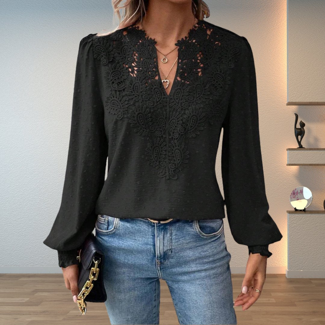 Women's elegant long-sleeve blouse featuring a beautiful lace bodice and stylish smocked cuffs. V-neck design.