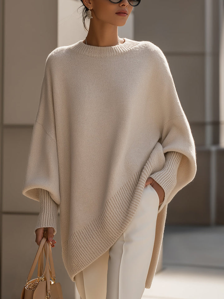 Close-up of an elegant women's oversized knit sweater, showing soft texture.
