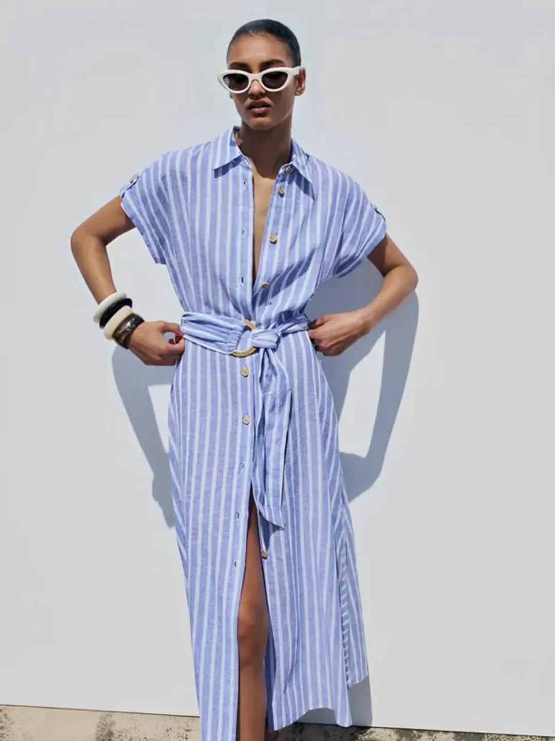 Elegant women's long striped belted dress, featuring a button-down front, ideal for office or summer casual.