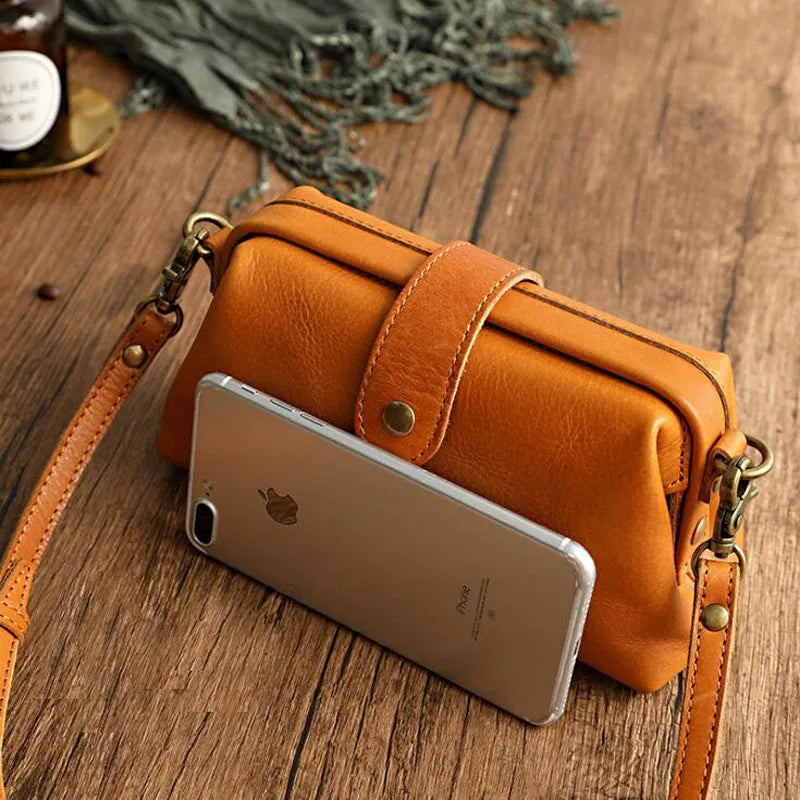 Classic vintage doctor bag style women's handbag, a fashionable PU leather shoulder and crossbody accessory.