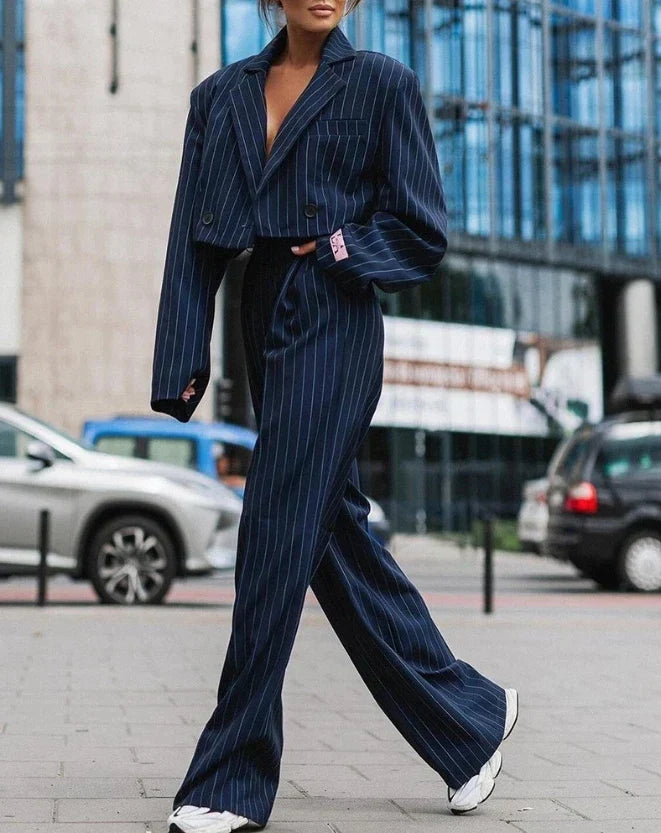 Chic women's tailored suit featuring a classic blazer and matching trousers, perfect for formal and elegant events.