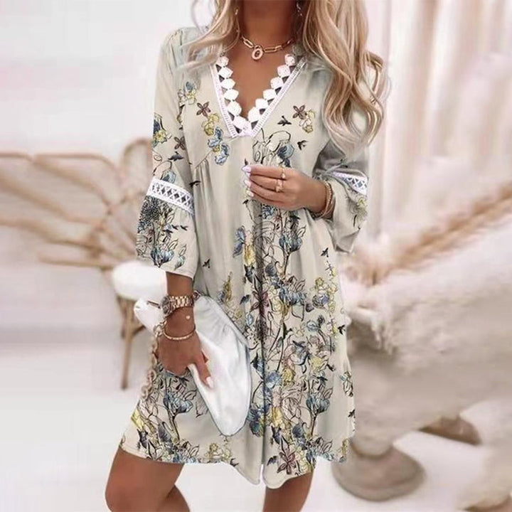 Stylish women's v-neck, short sleeve bohemian mini dress in a vibrant print, perfect for summer fashion.