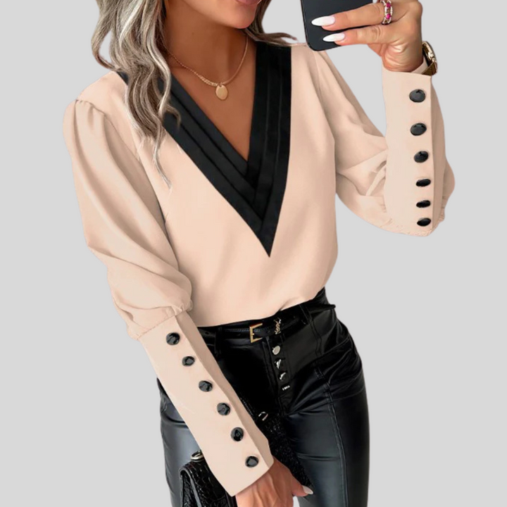 Versatile women's long sleeve elegant top, detailed with a button-front and fashionable gigot sleeves.