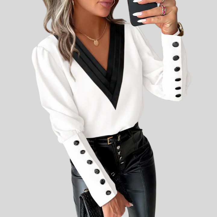 Chic women's fashion blouse featuring a sophisticated button-front design and dramatic gigot statement sleeves.