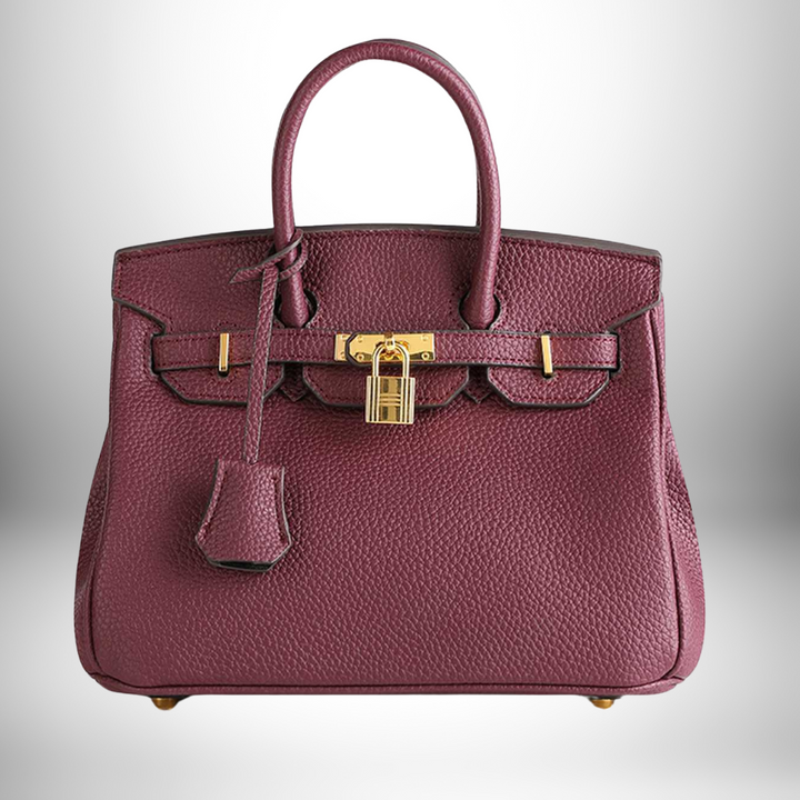 Women's stylish leather shoulder bag, intricate embossed design and luxurious gold hardware.