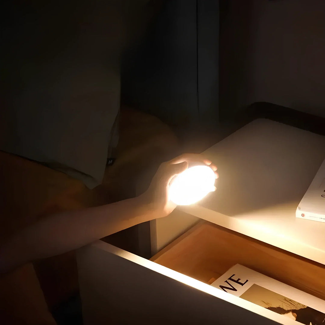 Modern LED motion sensor night light, providing instant illumination with magnetic, wireless installation.