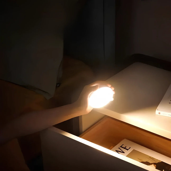 Modern LED motion sensor night light, providing instant illumination with magnetic, wireless installation.